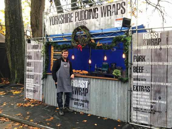 Man standing in front of outdoor stall selling Yorkshire pudding wraps
